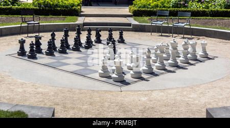 Giant chess board in the Rijksmuseum (National Museum) gardens. Anyone can enjoy a game of chess with friends or with random people. Stock Photo