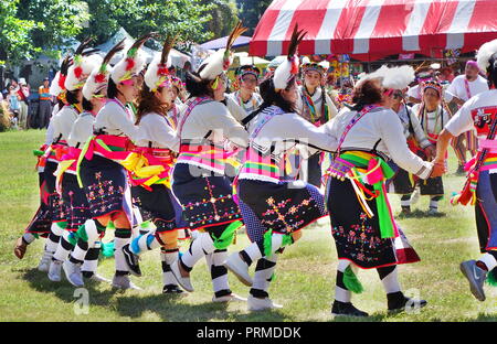 KAOHSIUNG, TAIWAN -- SEPTEMBER 29, 2018: Members of the indigenous Amis tribe in traditional costumes participate in the yearly harvest festival. Stock Photo