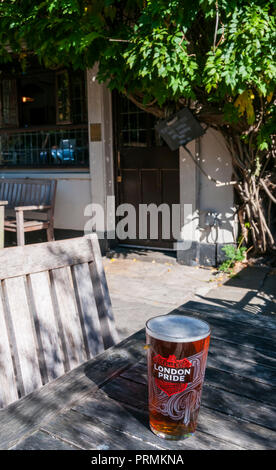 A pint of Fullers London Pride beer on a table outside the Flask public house in Highgate, North London. Stock Photo