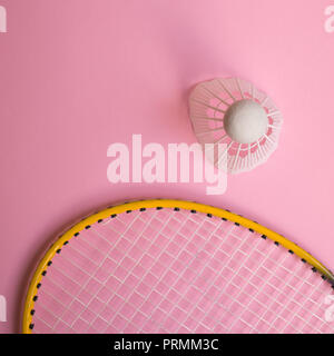 Close up shuttlecock and badminton racket on pinl background. Stock Photo