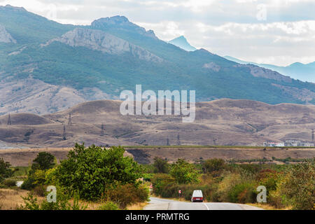 Car moves along the highway in a beautiful mountainous area Stock Photo