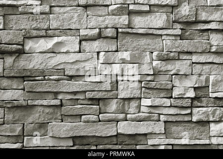 Front view of monotone grey rough stone wall for background or banner Stock Photo