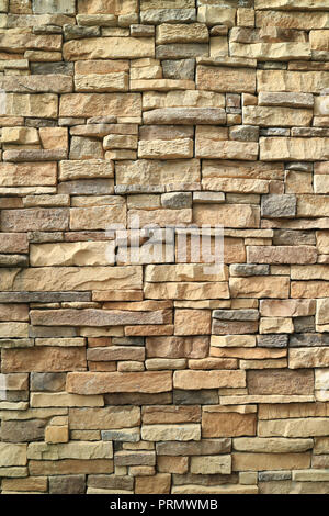 Vertical photo of brown and gray rough stone wall for background or banner Stock Photo