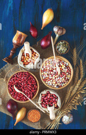 Assortment of kidney bean - mung bean, red kidney bean, white bean, brown bean, indian corn, pumpkin seeds, lentils, onions, garlic, wheat sprouts on  Stock Photo
