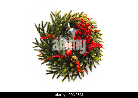 christmas wreath new year isolated on white background. beautiful spruce wreath with red flowers, balls, berries and stars. Stock Photo