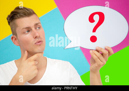 portrait of blond man holding a speech bubble with a question mark Stock Photo