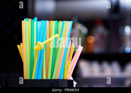 Bright multi colored straws for a cocktail on the bar. Stock Photo
