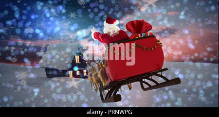 Composite image of santa claus riding on sled with gift box Stock Photo