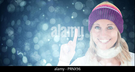 Composite image of positive woman showing up smiling at the camera against white background Stock Photo