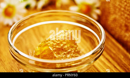 Honeycomb in glass bowl. Close-up of honey. Healthy organic. Sweet dessert background Stock Photo