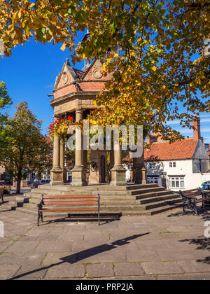 The Fountain former water pump in St James Square in early autumn at Boroughbridge North Yorkshire England Stock Photo