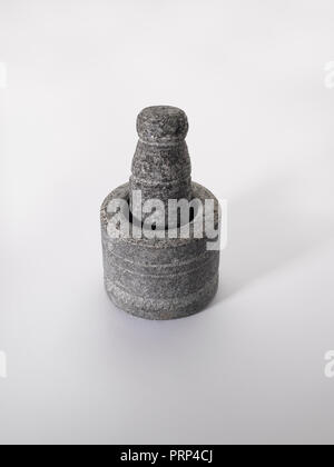 Stone grinder and pestle  on a white background Stock Photo