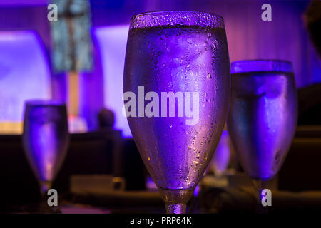 Water Glass Sweating With Blue Light In Restaurant Stock Photo