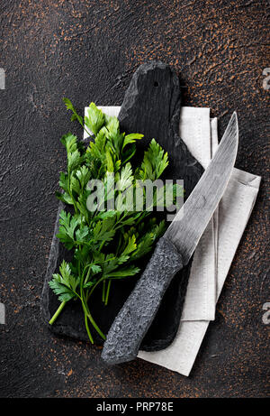 Parsley and knife on cutting board Stock Photo