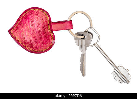 door keys on pink colored embossed leather heart shaped key ring cutout on white background Stock Photo