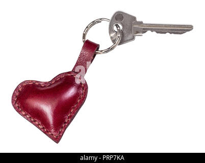 door key on handmade burgundy leather heart shaped key fob cutout on white background Stock Photo