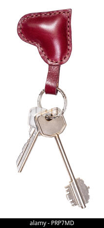 two door keys on handmade burgundy leather heart shaped key fob cutout on white background Stock Photo