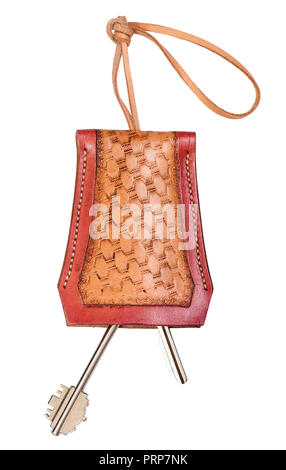 two door keys in handmade embossed leather Key Holder cut out on white background Stock Photo