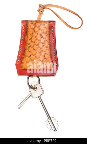 door keys on handmade embossed leather Key Case cut out on white background Stock Photo