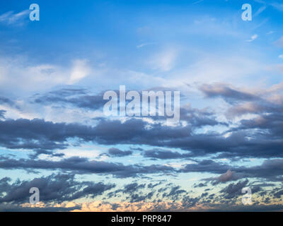 dark gray rainy clouds in autumn sunset sky Stock Photo