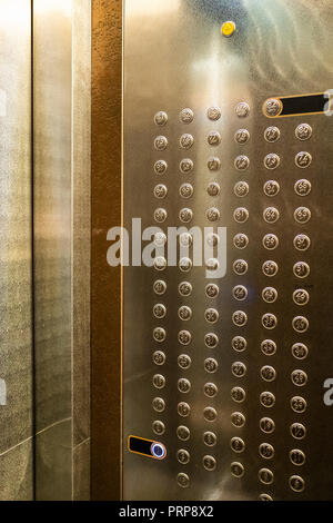 many buttons in cabin of modern elevator in skyscraper Stock Photo
