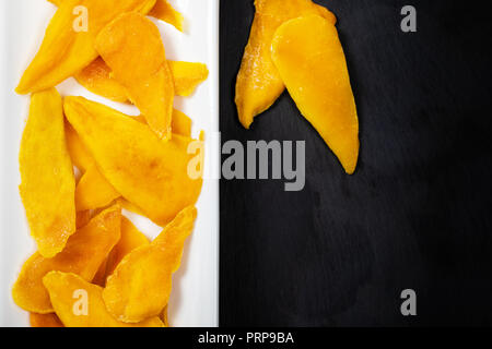 Dried Mango Fruit on Black Background Stock Photo