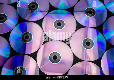 CDs / DVDs lying on a black background with reflections of light. Stock Photo