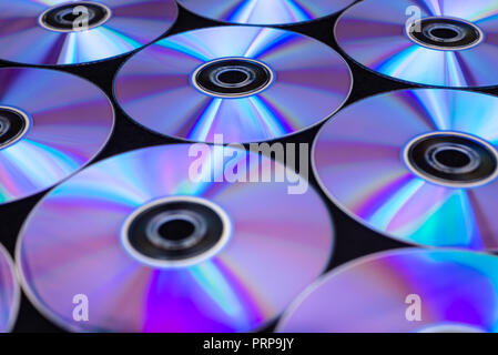 CDs / DVDs lying on a black background with reflections of light. Stock Photo