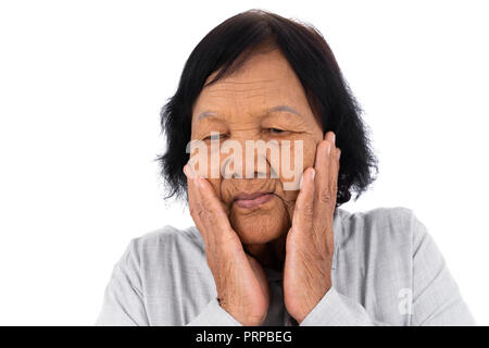 Senior woman suffering from toothache isolated on a white background Stock Photo