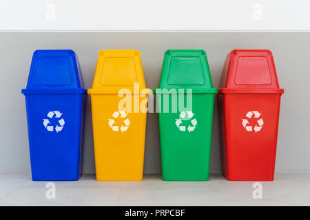 four colorful recycle bins on the floor Stock Photo