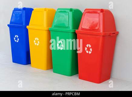 four colorful recycle bins on the floor Stock Photo