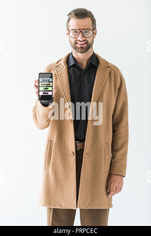 smiling developer presenting smartphone with SEO ideas, isolated on white Stock Photo