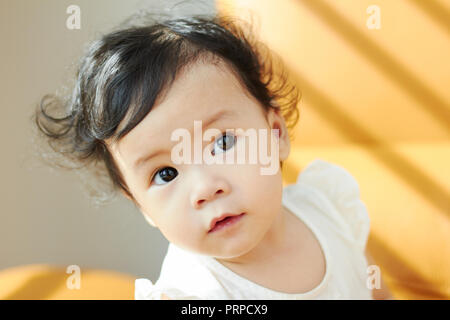 Portrait of cute and lovely curly hair asian chinese baby girl . Stock Photo