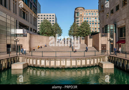 View of the steps that lead to Cabot Square from the  Middle Dock in the Canary Wharf Development in London's Docklands. Stock Photo