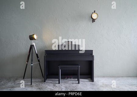 Modern living room with piano,clock and lamp stand . cement floor and concrete wall , Interior design with Loft style . Stock Photo