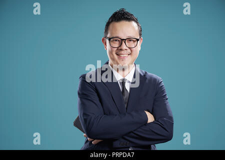 Portrait of smile asian businessman in suit . isolated on light blue background . Stock Photo