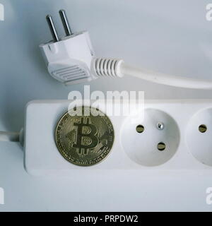 bitcoin cryptocurrency energy consumption concept. Gold coin with electric  plug Stock Photo - Alamy