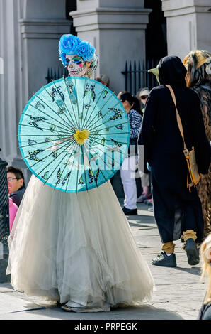 A street performer dressed as La Catrina stands outside St. Louis Cathedral in Jackson Square, November 11, 2015, in New Orleans, Louisiana. Stock Photo