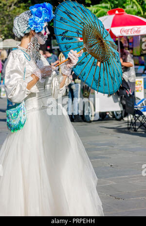 A street performer dressed as La Catrina stands outside St. Louis Cathedral in Jackson Square, November 11, 2015, in New Orleans, Louisiana. Stock Photo