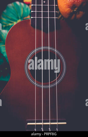 closeup photo of a ukulele against a Hawaiian background Stock Photo