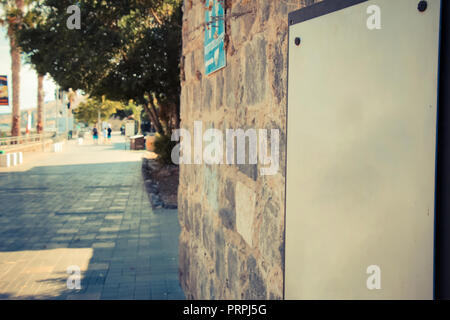 A blank sign on ancient brick wall at the Tiberias promenade. Stock Photo