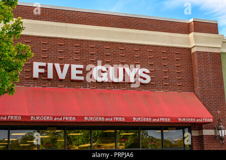 Five Guys hamburger restaurant front exterior entrance of the chain restaurant showing the corporate sign and logo in Montgomery, Alabama USA. Stock Photo