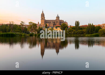 Salamanca Old and New Cathedrals reflected on Tormes River at sunset, Community of Castile and León, Spain.  Declared a UNESCO World Heritage Site in  Stock Photo