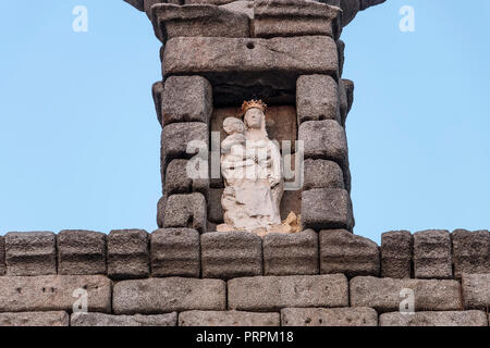 Detail of roman aqueduct, Virgin of the Aqueduct, located in the central niche of the monument has since the Plaza del Azoguejo, Segovia, Spain Stock Photo