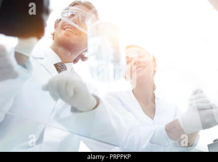 young scientists performing a reaction in the laboratory Stock Photo