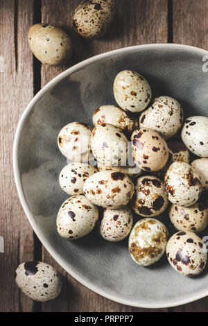 top view of raw organic quail eggs on plate wooden table Stock Photo