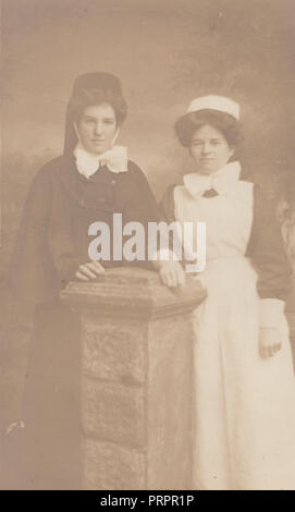 * Vintage Photograph of an Edwardian Midwife? and Edwardian Nurse or Maid Stock Photo
