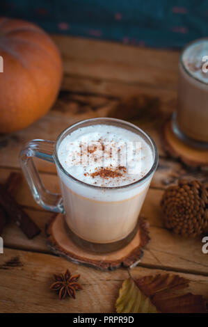 Pumpkin spice latte in glass cups, on wooden background Stock Photo