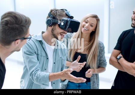 Positive colleagues testing virtual reality glasses Stock Photo