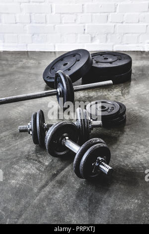 various gym equipment on concrete surface Stock Photo